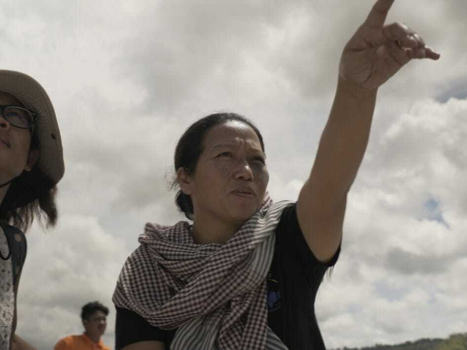 caption: Patima Tungpuchayakul (right), a Thai abolitionist, with members of her team on a trip to free enslaved fishermen.