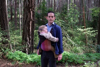 caption: Physician John Okrent and his 16-month-old daughter.