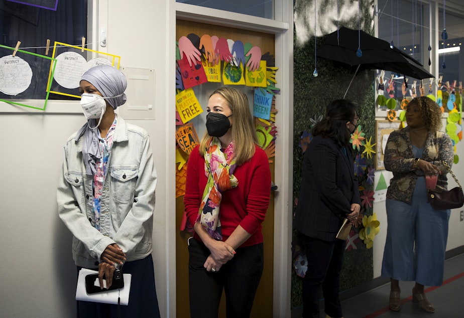 caption: CEO of Impact Public Schools Jen Davis Wickens, second from left, attends a tour of the school before the start of a board meeting on Friday, April 29, 2022, at Puget Sound Elementary School in Tukwila. 