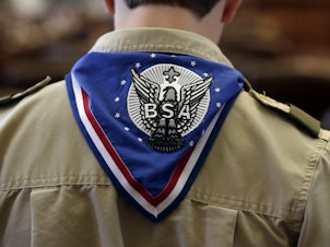 caption: A Boy Scout wears an Eagle Scot neckerchief during the annual Boy Scouts Parade and Report to State in the House Chambers at the Texas State Capitol, February 2013, in Austin, Texas.
