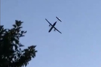 caption: A screenshot of the Bombardier Q400 turbojet before crashing from a video by Skylar Jacobson.