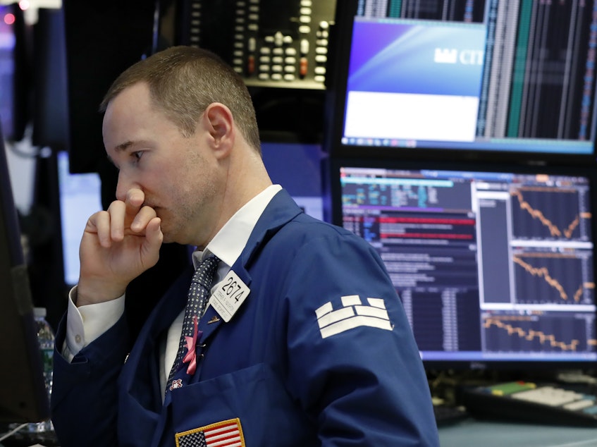 caption: Specialist Stephen Naughton works on the floor of the New York Stock Exchange on Thursday.