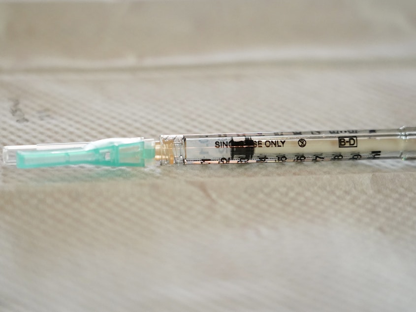 caption: A single-use syringe awaits to be filled with the Moderna COVID-19 vaccine. Moderna has sued rival drugmakers for patent infringement.