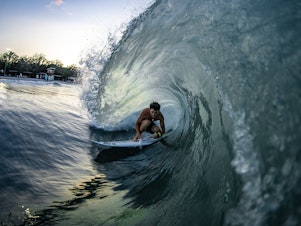 caption: Ben Elliott gets barreled at the BSR Surf Resort, where artificial waves are attracting world-class talent.