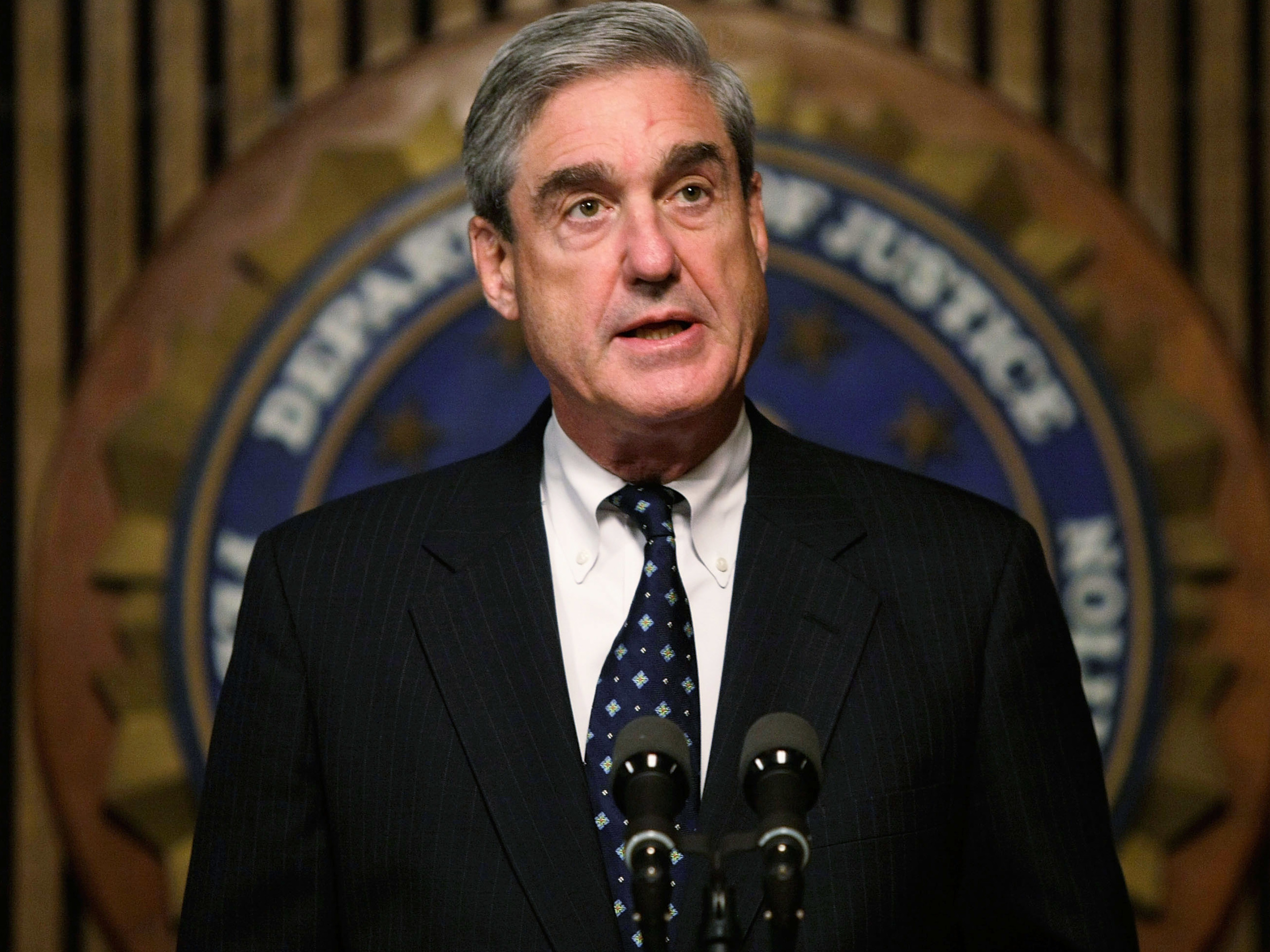 caption: WASHINGTON - JUNE 25: FBI Director Robert Mueller speaks during a news conference at the FBI headquarters June 25, 2008 in Washington, DC. The news conference was to mark the 5th anniversary of Innocence Lost initiative. (Photo by Alex Wong/Getty Images)