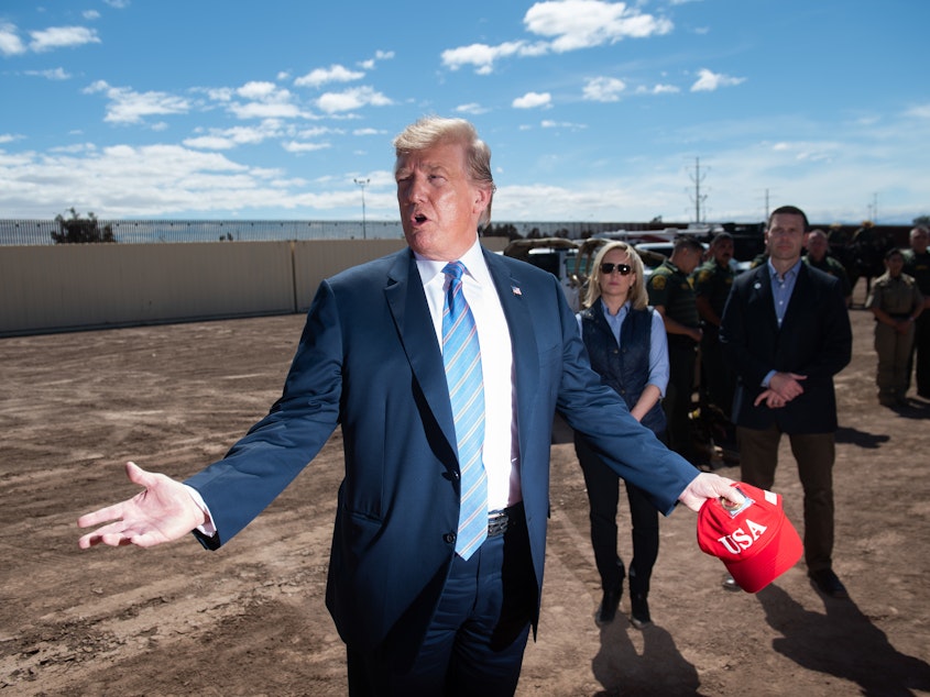 caption: President Trump tours a portion of the border wall between the United States and Mexico in Calexico, Calif., last month.