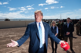 caption: President Trump tours a portion of the border wall between the United States and Mexico in Calexico, Calif., last month.