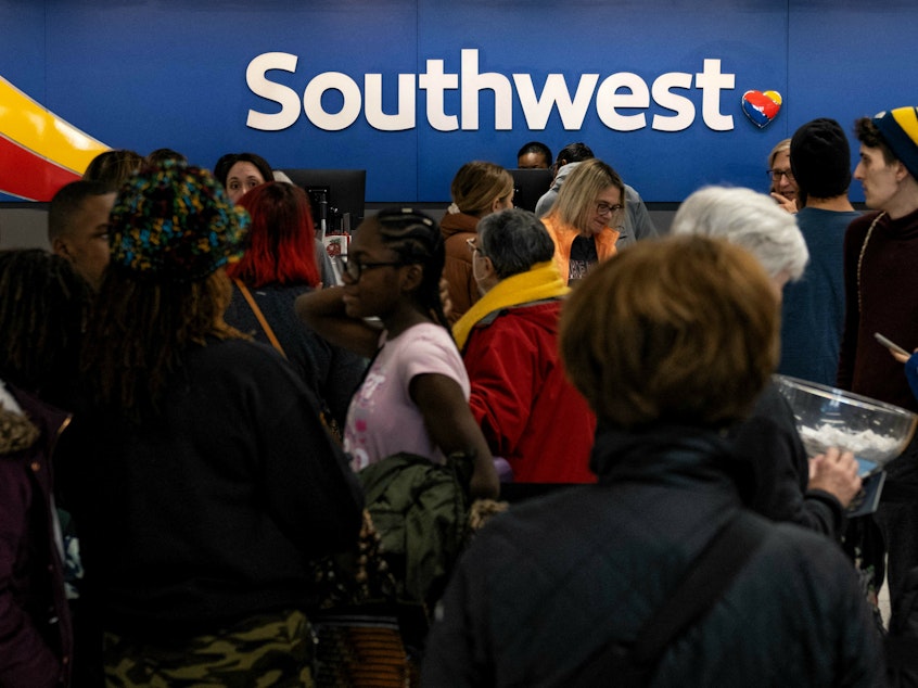 caption: Travelers wait in line at the Southwest Airlines ticketing counter at Nashville International Airport after the airline canceled thousands of flights in Nashville, Tenn., on Dec. 27, 2022. The Department of Transportation is investigating the disaster, which led to $220 million in losses for Southwest