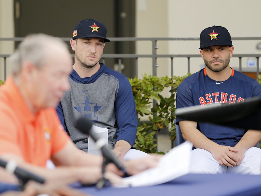 caption: Houston Astros players Alex Bregman and José Altuve looked on as owner Jim Crane addressed reporters during a news conference Thursday in West Palm Beach, Fla.