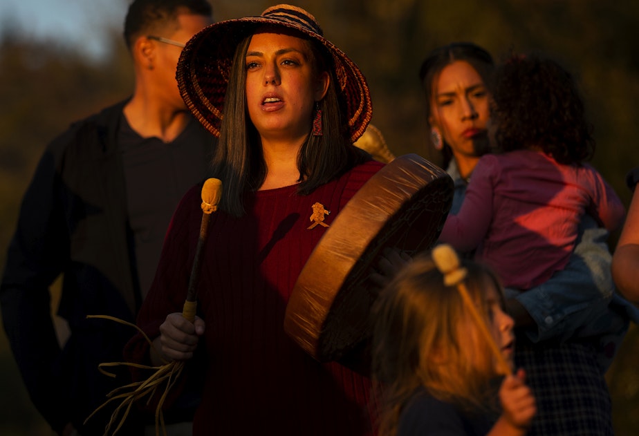 caption: Snoqualmie tribal member Bethany Fackrell sings before the release of endangered juvenile kokanee salmon into Lake Sammamish on Wednesday, October 12, 2022.