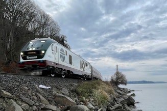 caption: The Amtrak Cascades heads north in Shoreline, Washington, on Nov. 30, 2023.