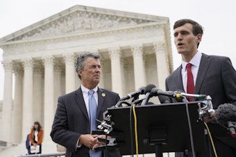 caption: Alabama Solicitor General Edmund LaCour (right) speaks alongside Alabama Attorney General Steve Marshall after oral arguments in an Alabama congressional redistricting case outside the U.S. Supreme Court in Washington, D.C., in 2022.