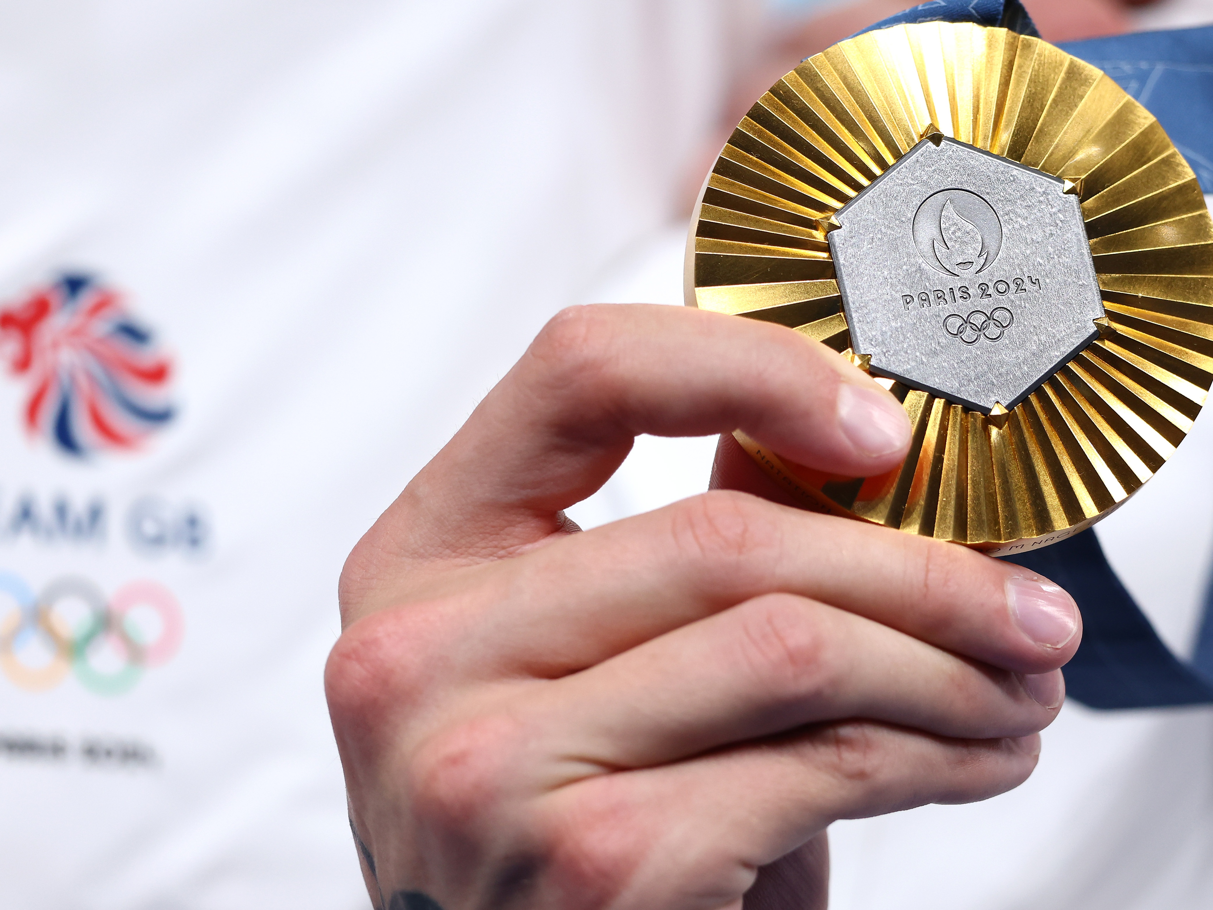 caption: Gold medals are the big prize in Paris. China and the U.S. are running neck and neck when it comes to gold. But on a per capita basis tiny Australia is punching above its weight.