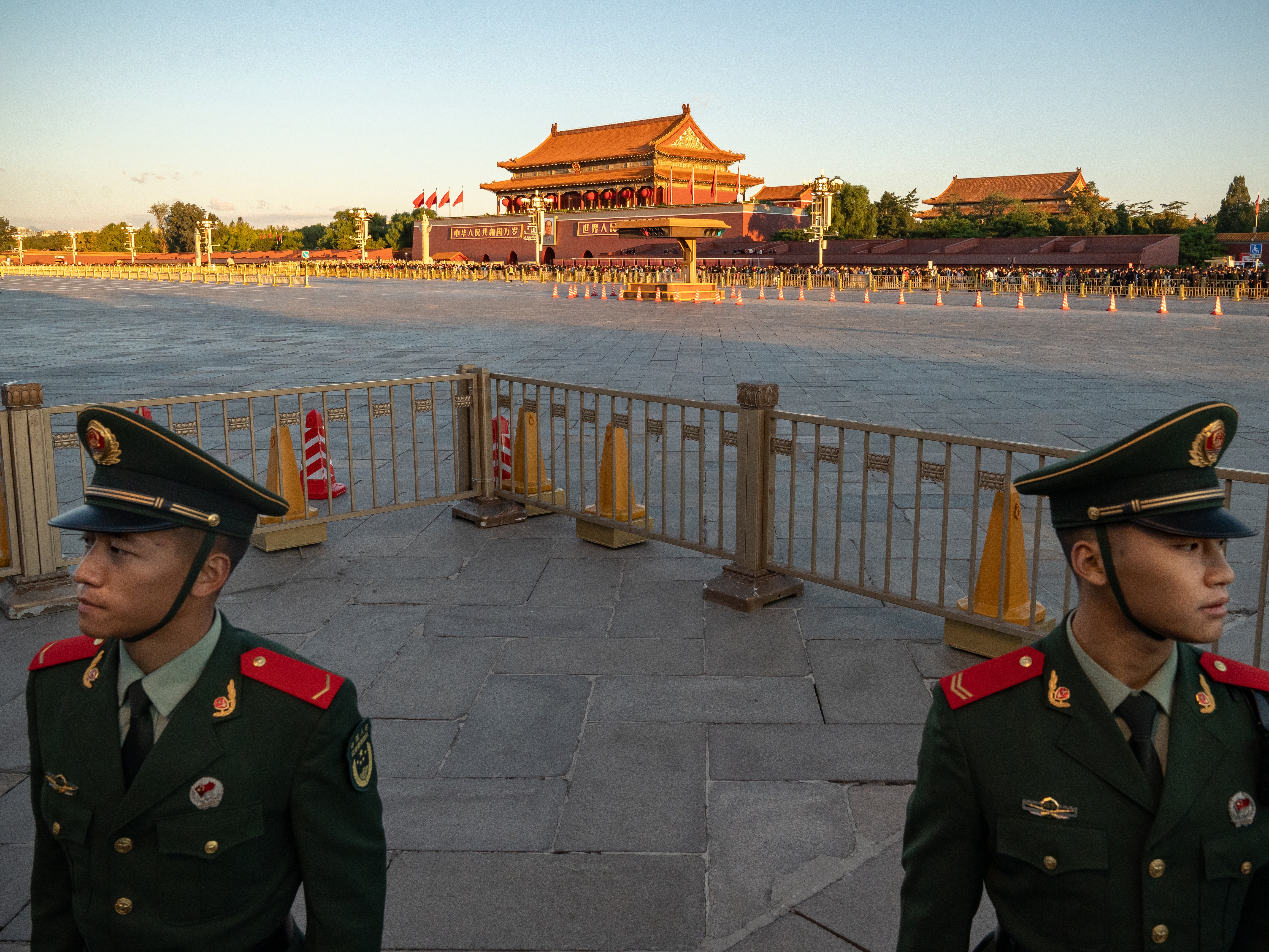 caption: People's Liberation Army soldiers stand guard in Tiananmen Square at the end of the flag-raising ceremony marking the 75th anniversary of the founding of the People's Republic of China, in Beijing, on Oct. 1.