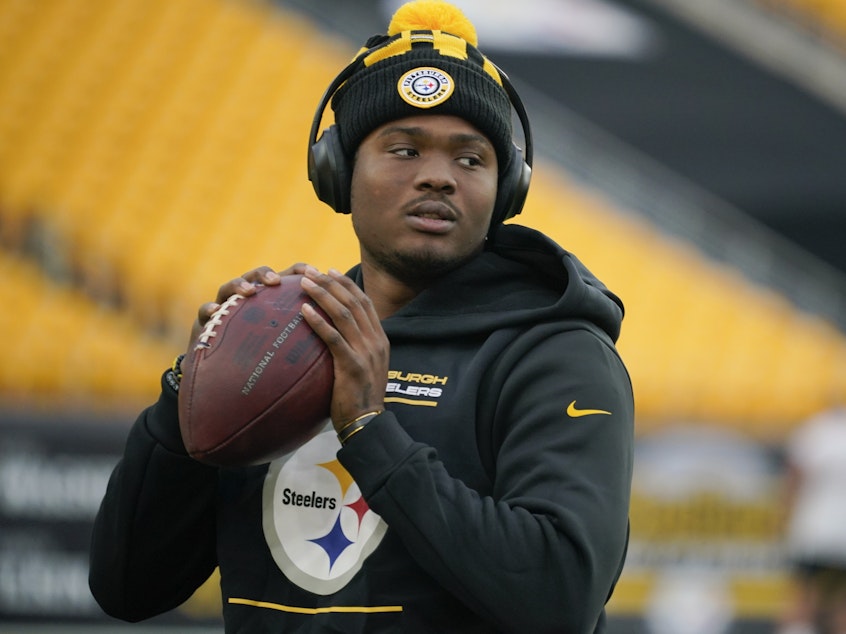 caption: Pittsburgh Steelers quarterback Dwayne Haskins warms up before a game against the Baltimore Ravens on Dec. 5, 2021, in Pittsburgh.