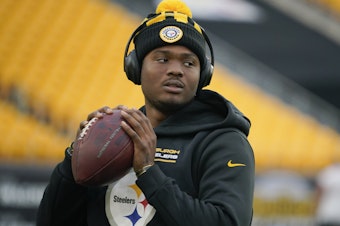 caption: Pittsburgh Steelers quarterback Dwayne Haskins warms up before a game against the Baltimore Ravens on Dec. 5, 2021, in Pittsburgh.