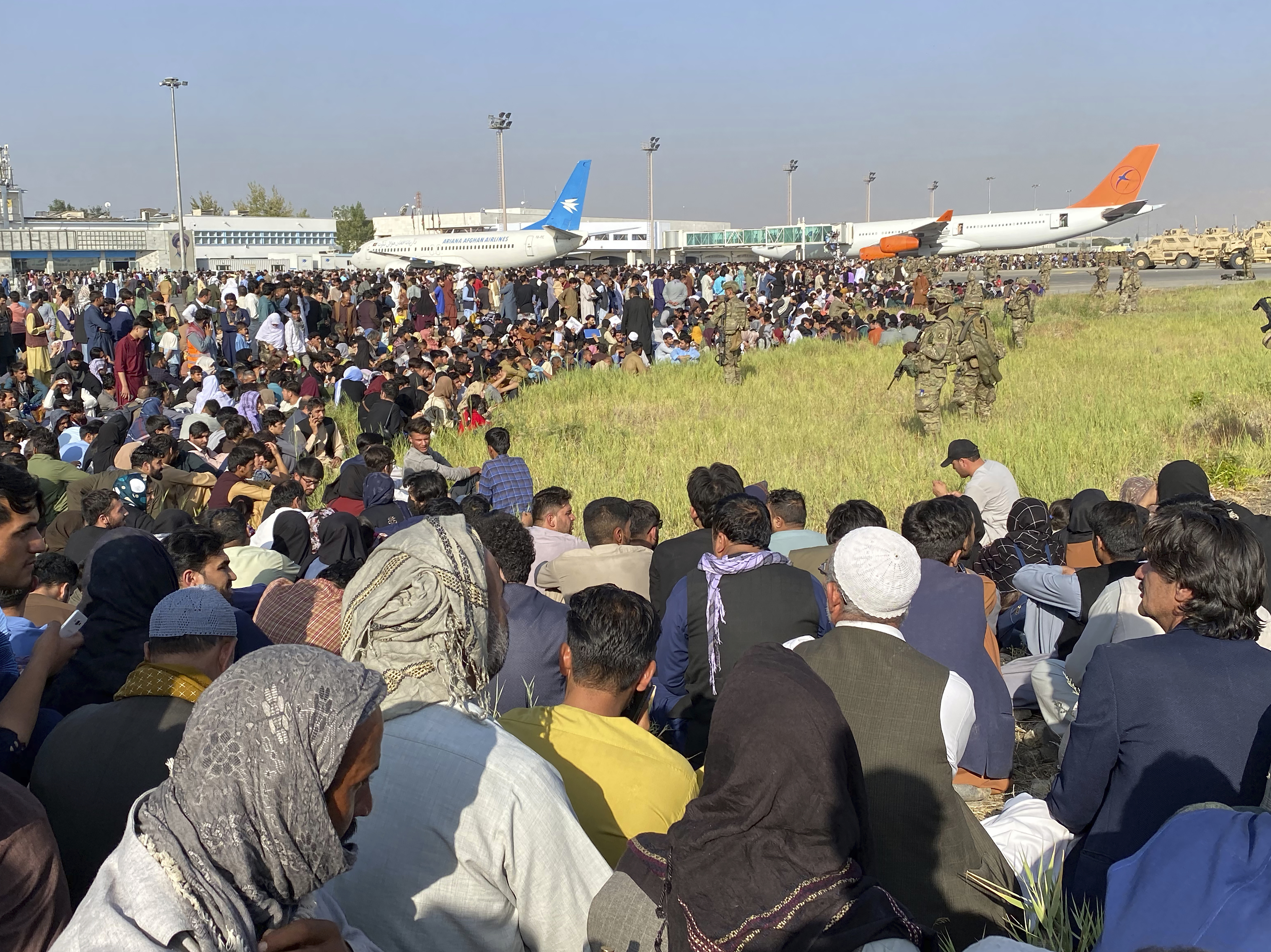 caption: U.S. soldiers stand guard along the perimeter at the international airport in Kabul Aug. 16, 2021.