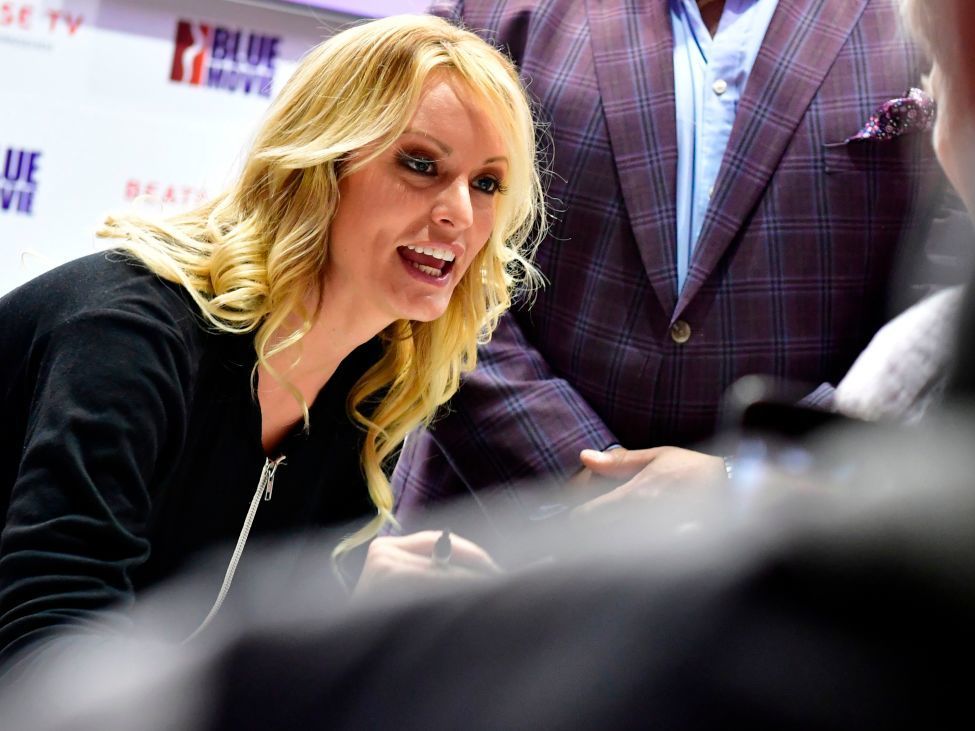 caption: Adult film actress Stormy Daniels signs autographs at the Venus Fair for Erotic Entertainment and Lifestyle in October in Berlin.