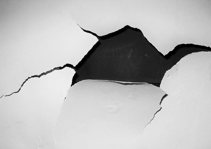 caption: A hole punched in a wall.