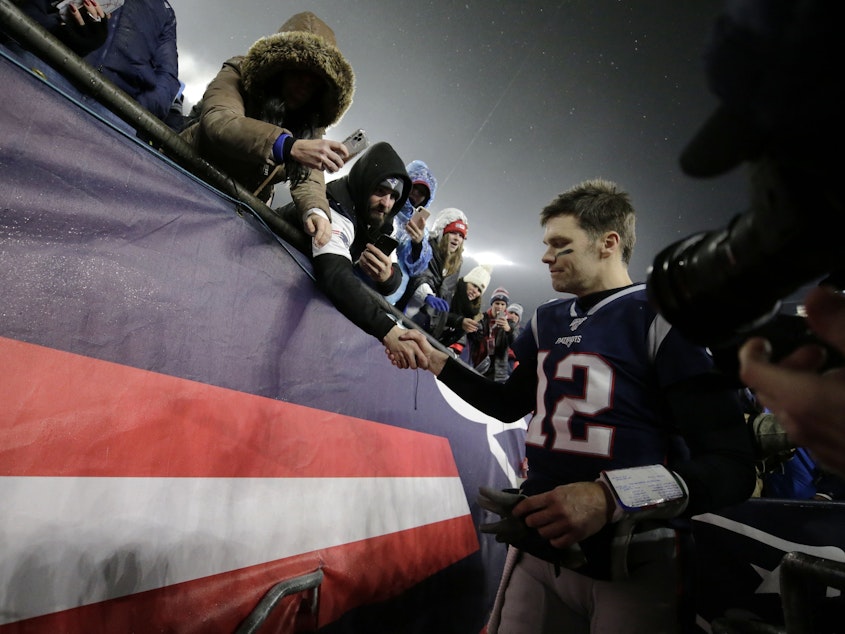 caption: Tom Brady shakes hands with a fan as he leaves the field in Foxborough, Mass., after losing a playoff football game to the Tennessee Titans earlier this year. As it turns out, that was likely the final game the quarterback would play in a New England Patriots uniform. He announced his departure Tuesday.