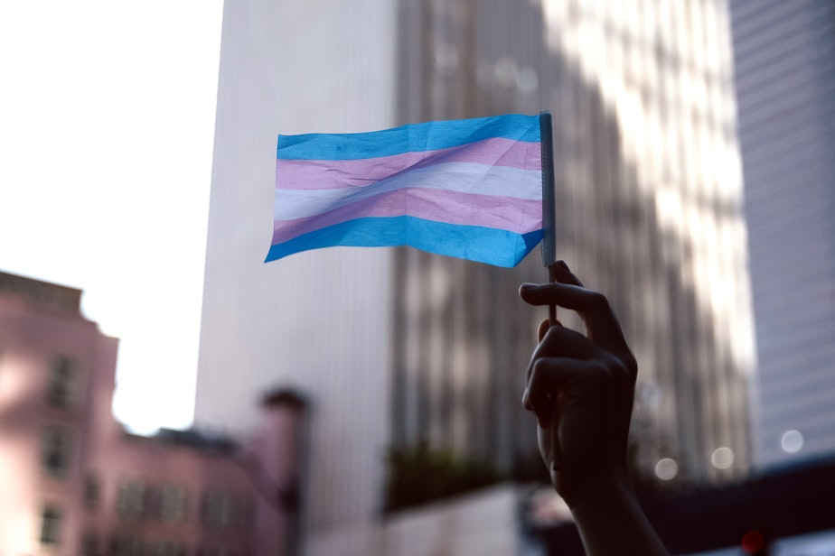 caption: A counter-protester waves a trans pride flag outside of the fundamentalist Christian group Mayday USA’s ‘Rattle in Seattle’ event, on Tuesday, May 27, 2025, outside of Seattle City Hall. Mayday USA advocates against trans rights.