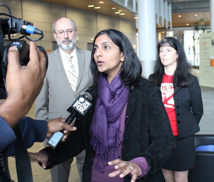 caption: City Council candidate Kshama Sawant, a member of the Socialist Alternative Party, with Democratic Party supporters Daniel Norton and Jeanne Legault.