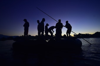 caption: Honduran migrants arrive at dawn Monday in Ciudad Hidalgo, in Mexico's far southwest. They used a makeshift raft to cross the Suchiate River, which forms part of the natural border between Guatemala and Mexico.