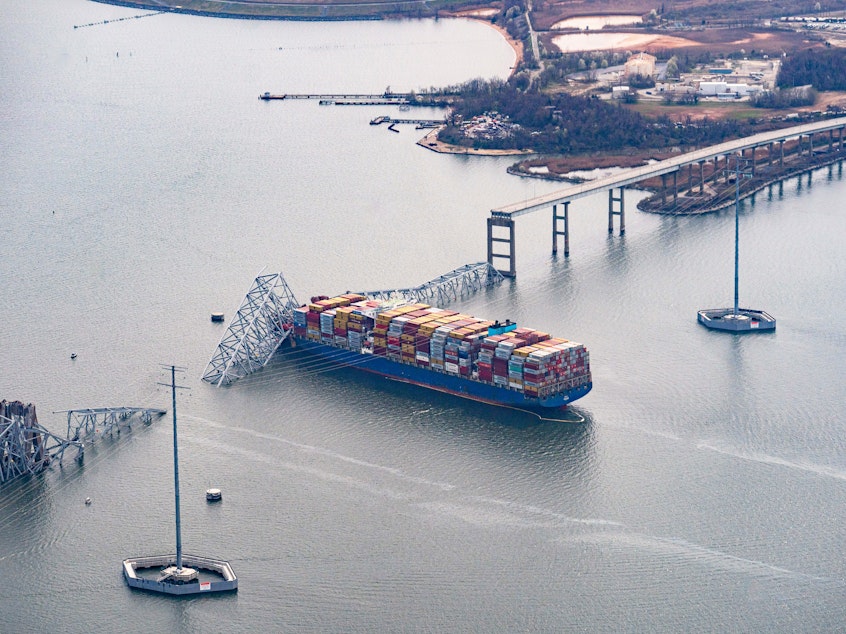 caption: The Dali container vessel after striking the Francis Scott Key Bridge that collapsed into the Patapsco River in Baltimore, on Tuesday. The Port of Baltimore, which has the highest volume of auto imports in the U.S., is now temporarily closed.
