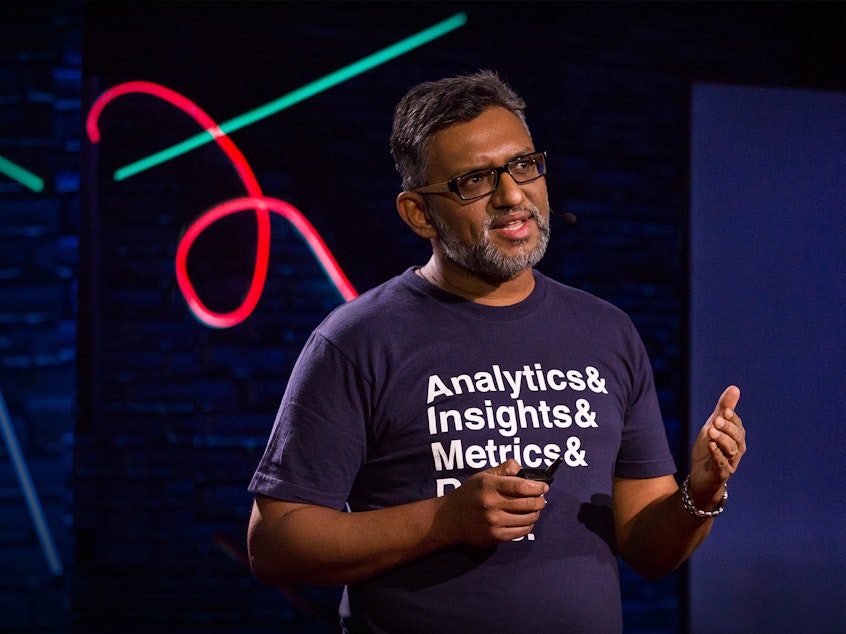 caption: Lux Narayan on the TED stage.