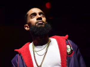 caption: One year after his death, fans of Nipsey Hussle are honoring the rapper's legacy by turning his motivational words into actions.