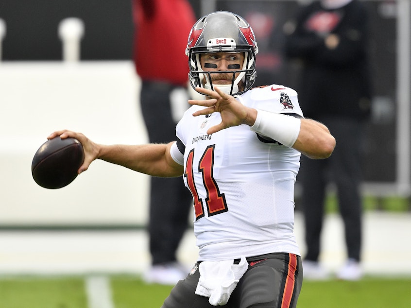 caption: Blaine Gabbert of the Tampa Bay Buccaneers warms up prior to their game against the Carolina Panthers at Bank of America Stadium in 2020 in Charlotte, North Carolina.