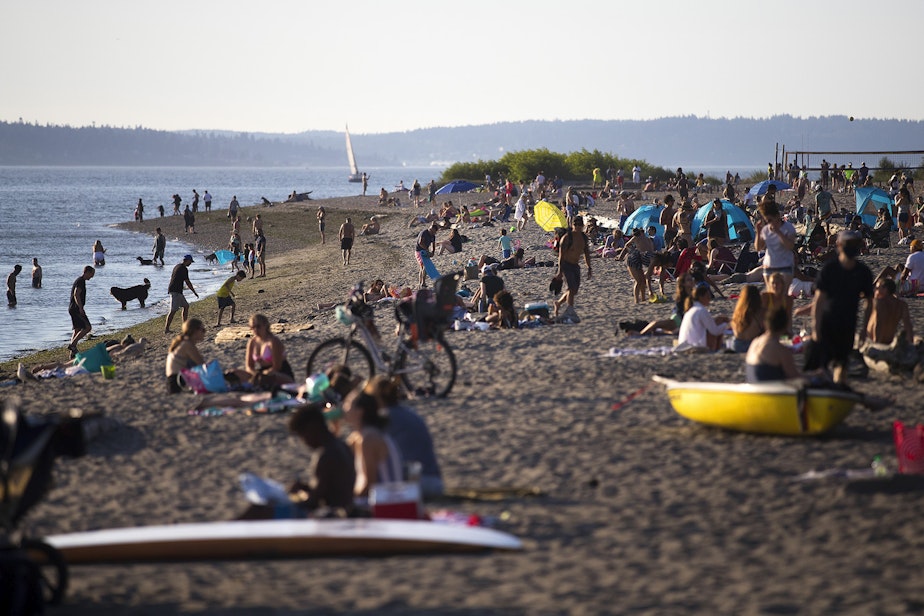 caption: Crowds gather on Wednesday, July 29, 2020, at Golden Gardens Park in Seattle as cases of Covid-19, along with related deaths, continue to dramatically rise in the region. 
