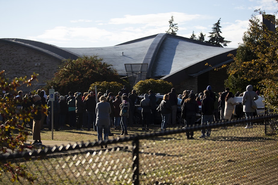 caption: Parents wait for their children to be released from school after a school shooting on Tuesday, November 8, 2022, at Ingraham high school in Seattle. 