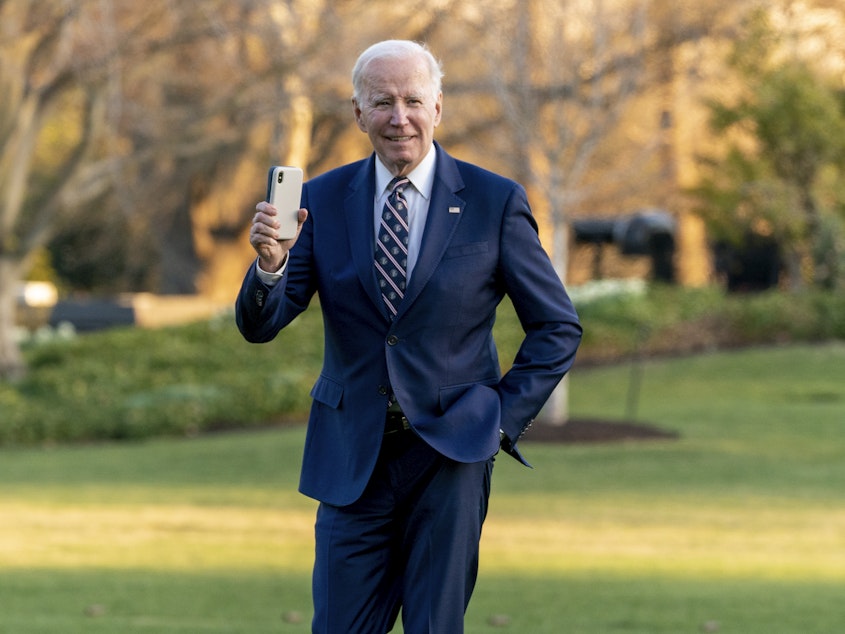 caption: President Biden waves as he arrives at the White House on March 9, 2023.