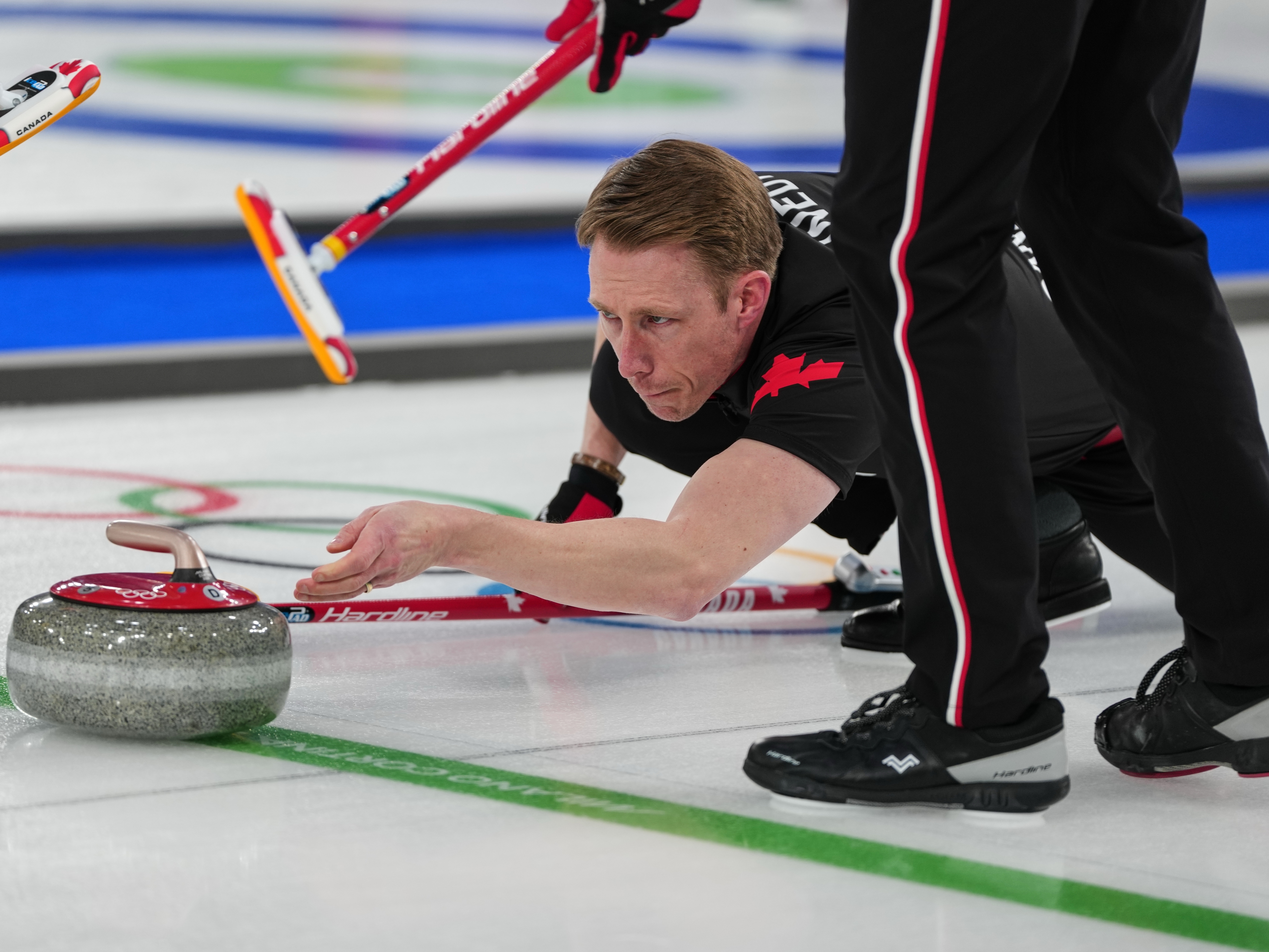 caption: Canada's Marc Kennedy in action during the men's curling round robin session against Sweden, at the 2026 Winter Olympics, in Cortina d'Ampezzo, Italy, Friday, Feb. 13, 2026.