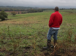 caption: Dan Hanrahan works on his farm on October 10, 2019 in Cumming, Iowa. Hanrahan said that "the Iowa caucuses allow a rural area to have a say in the political process."