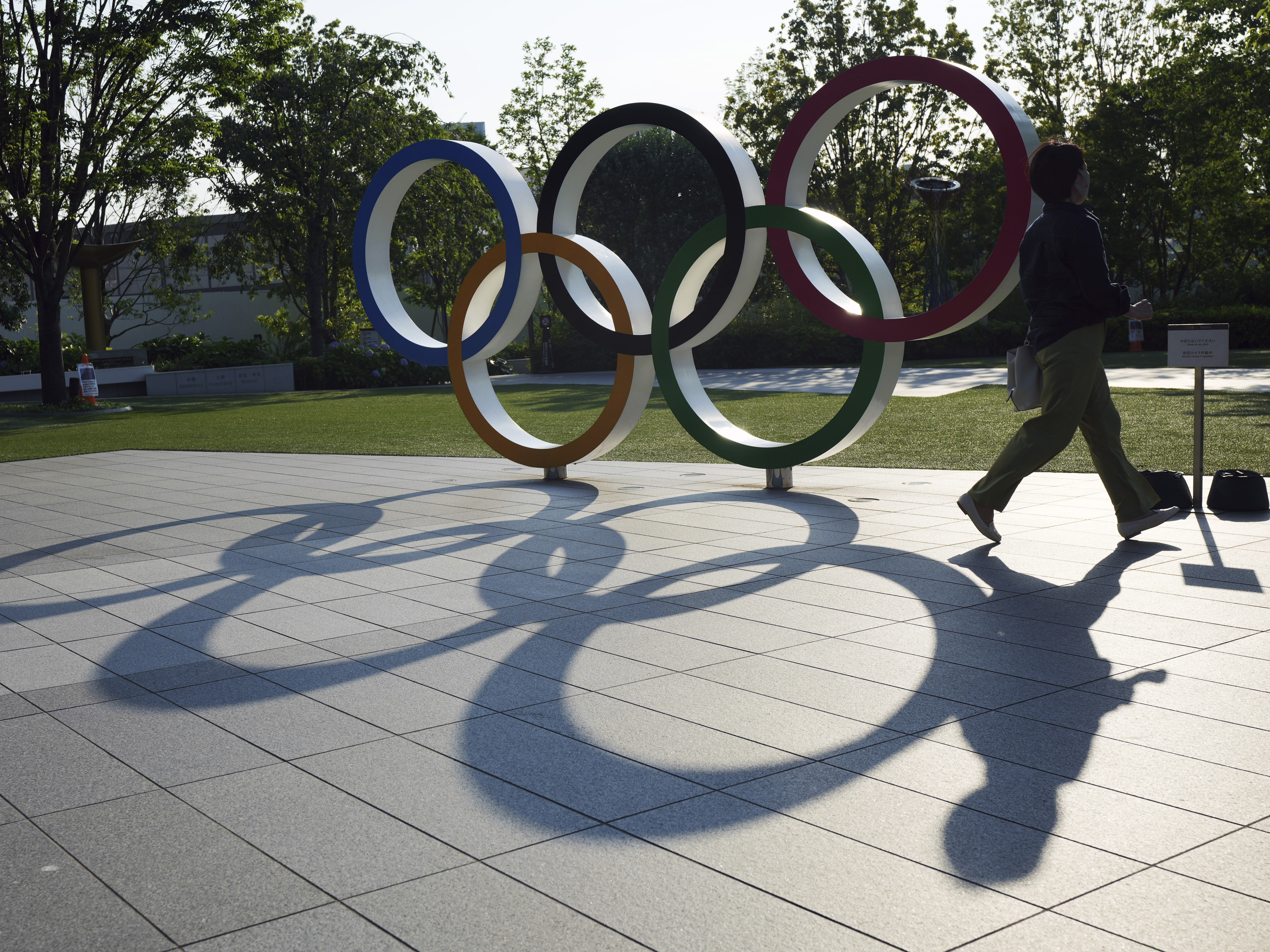 caption: The Olympic Rings near the National Stadium in Tokyo. Critics of the decision to allow local spectators into the games warn the huge event could lead to an increase in coronavirus infections.