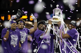 caption: The Washington Huskies, seen here celebrating with the trophy after beating the Texas Longhorns in the Sugar Bowl in New Orleans, quickly rebuilt its roster by using transfers and players from out of state — particularly California.