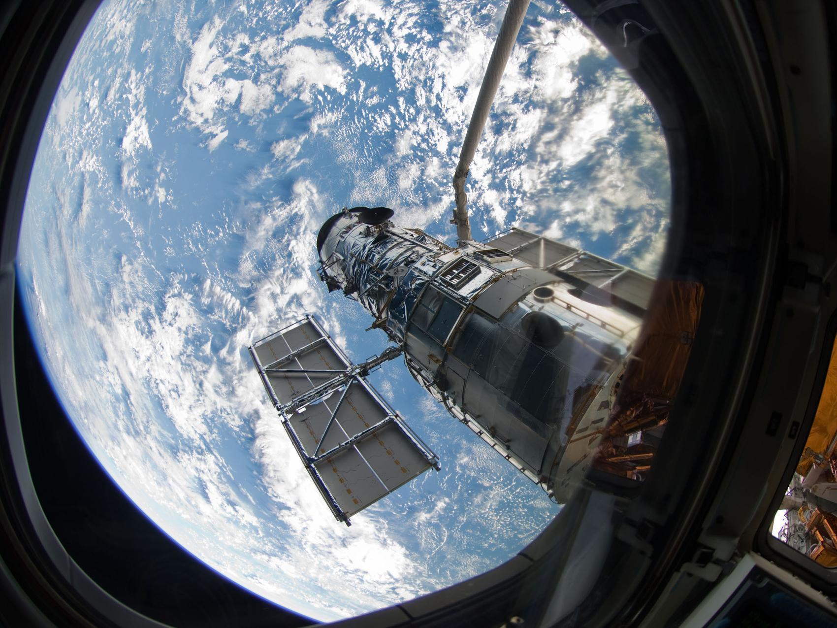 caption: An STS-125 crew member onboard the Space Shuttle Atlantis snapped a still photo of the Hubble Space Telescope following grapple of the giant observatory by the shuttle.