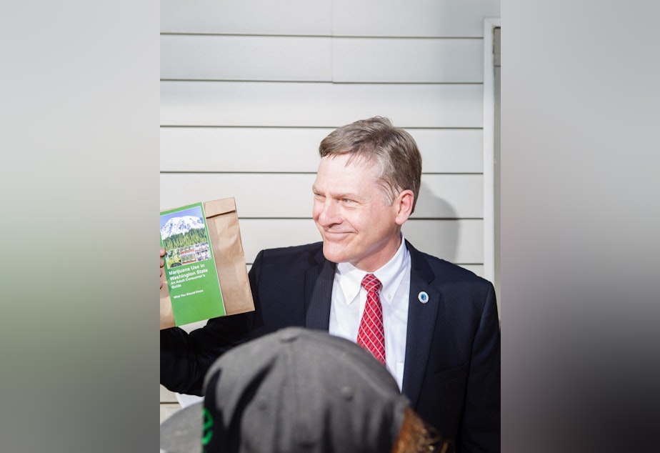 caption: Seattle City Attorney Pete Holmes bought pot in the city's first licensed store on opening day -- and then brought it back to his office.