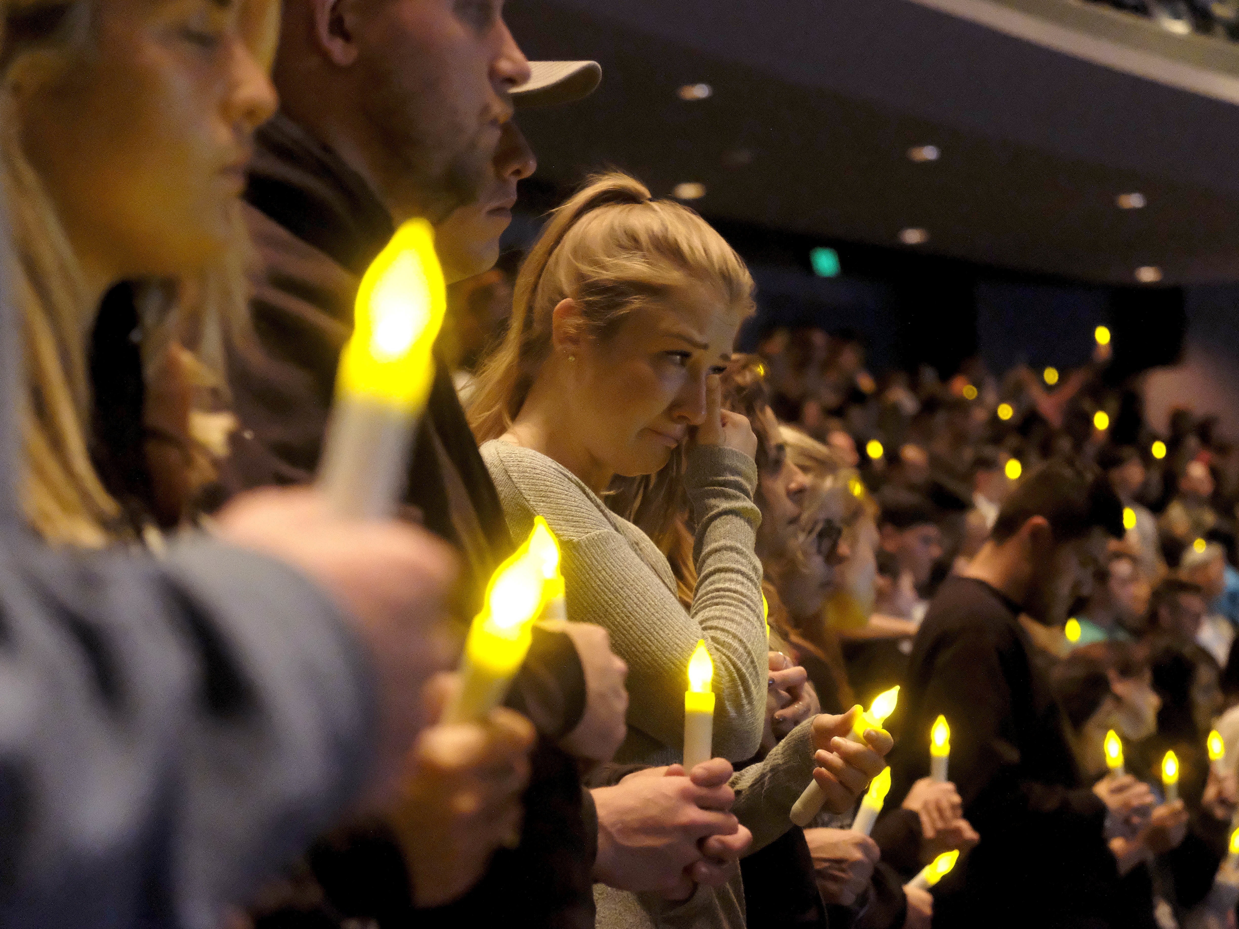 caption: People gather to pray for the victims of a mass shooting during a candlelight vigil in Thousand Oaks, Calif., Thursday, Nov. 8, 2018. A gunman opened fire Wednesday evening inside a country music bar, killing multiple people, including a responding sheriff's sergeant.