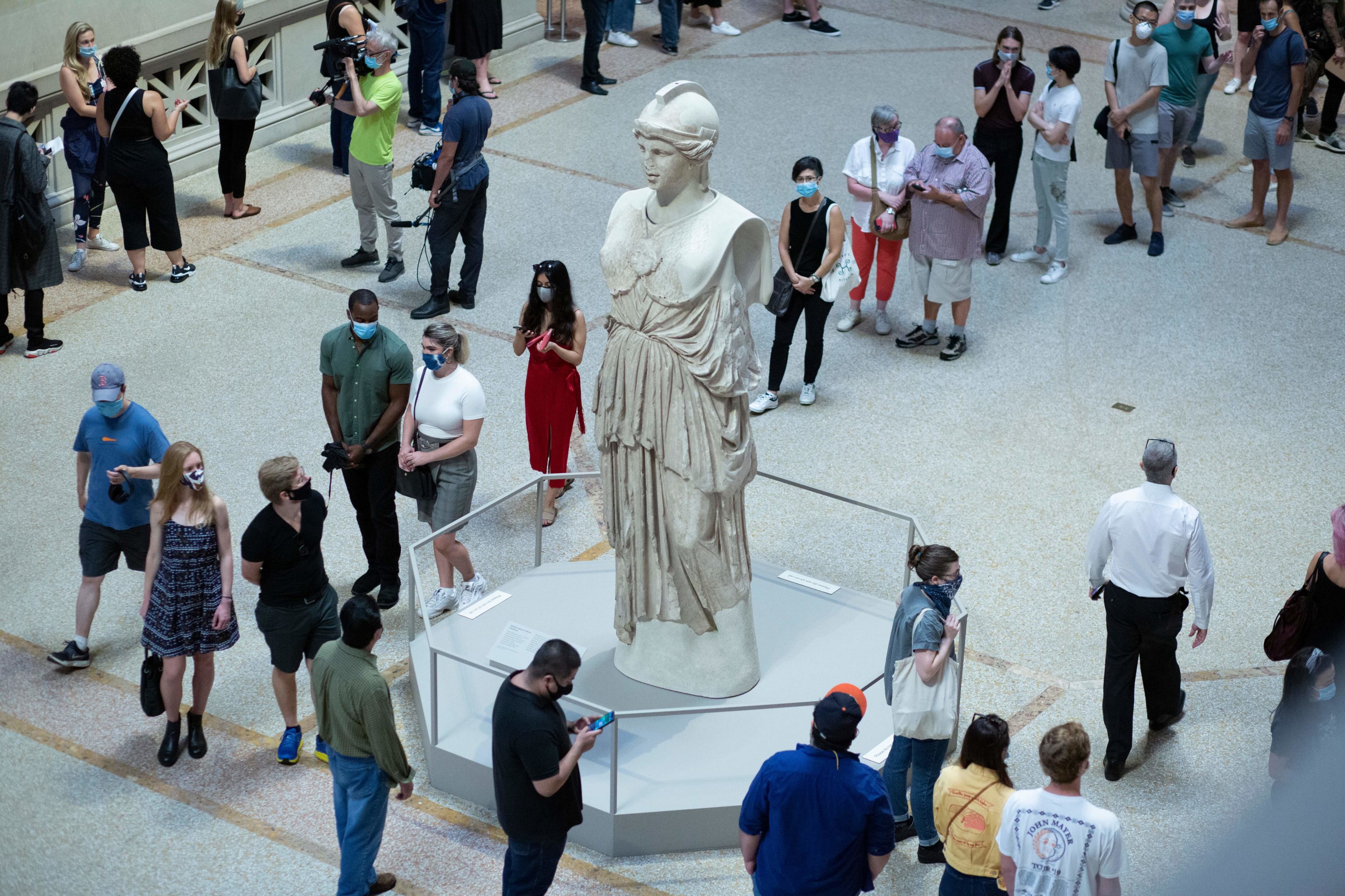 caption: Visitors line up as the Metropolitan Museum of Art in New York reopens to the public on August 29, 2020.(KENA BETANCUR/AFP via Getty Images)