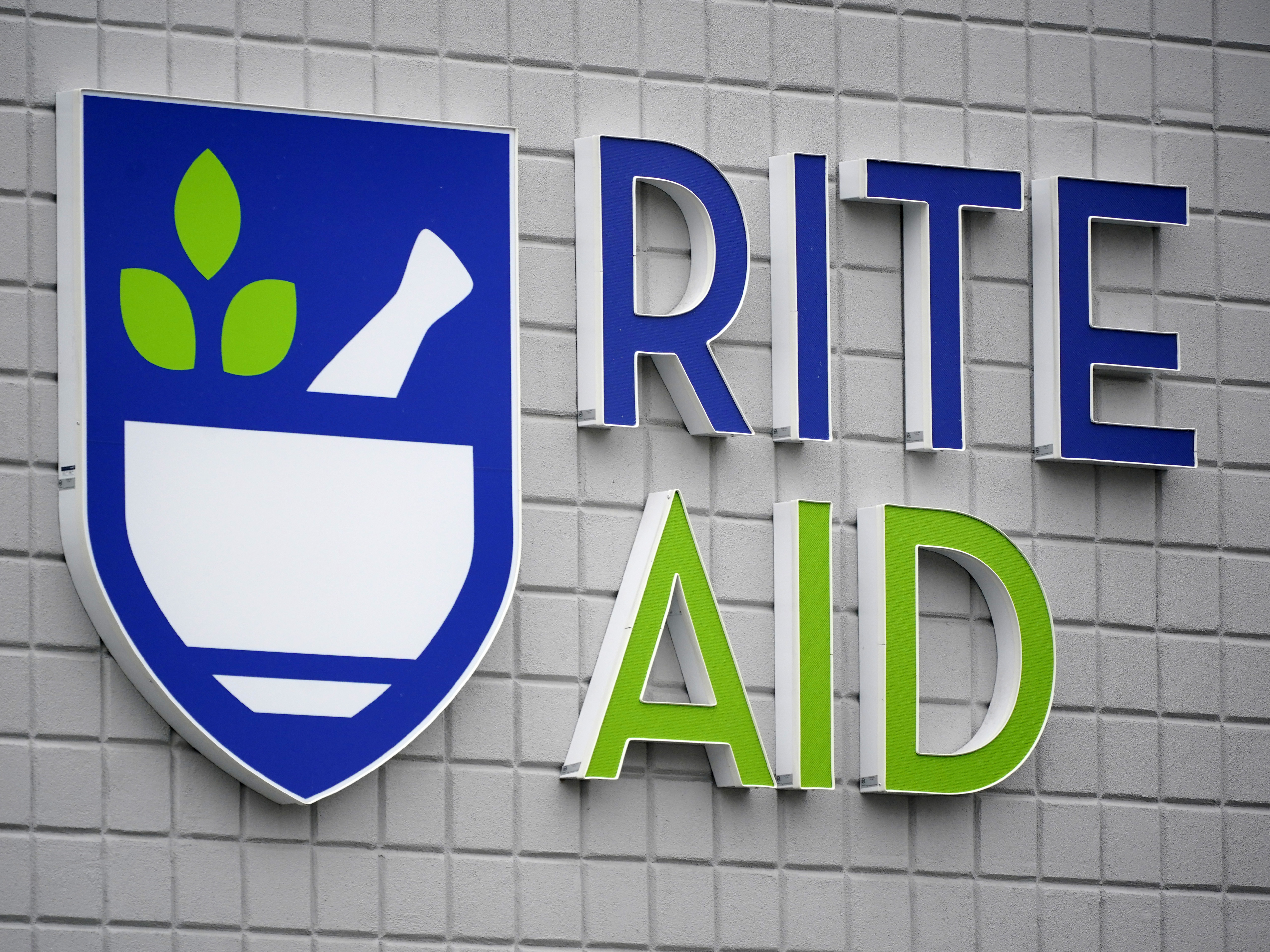 caption: This photo shows a sign of Rite Aid on its store in Pittsburgh on Jan. 23, 2023. Rite Aid, a major U.S. pharmacy chain, said Sunday, Oct. 15, that it has filed for bankruptcy as part of its effort to restructure its finances.