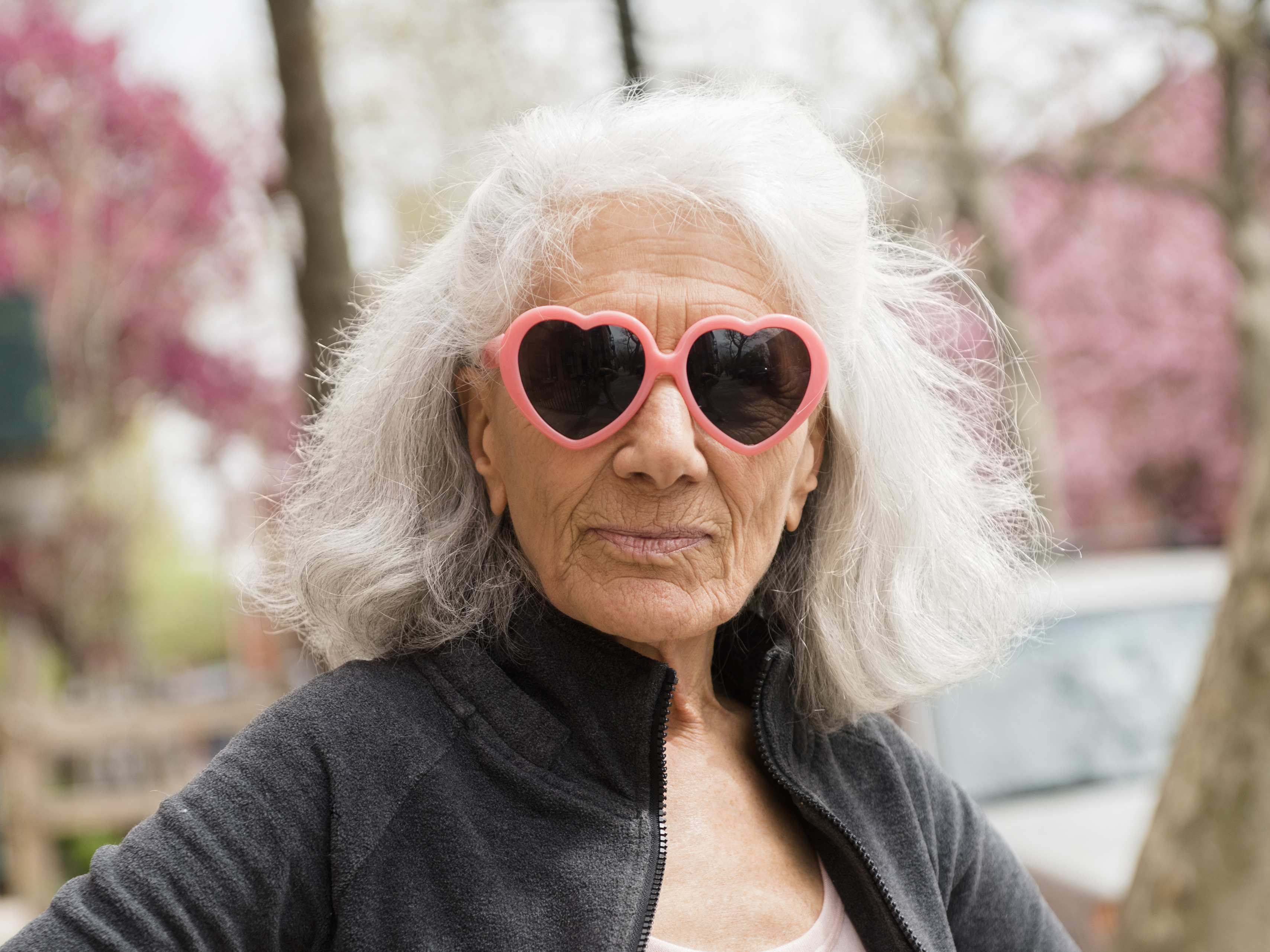 Older woman wearing heart-shape sunglasses