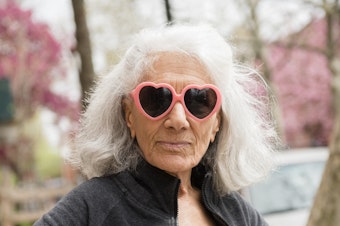 Older woman wearing heart-shape sunglasses