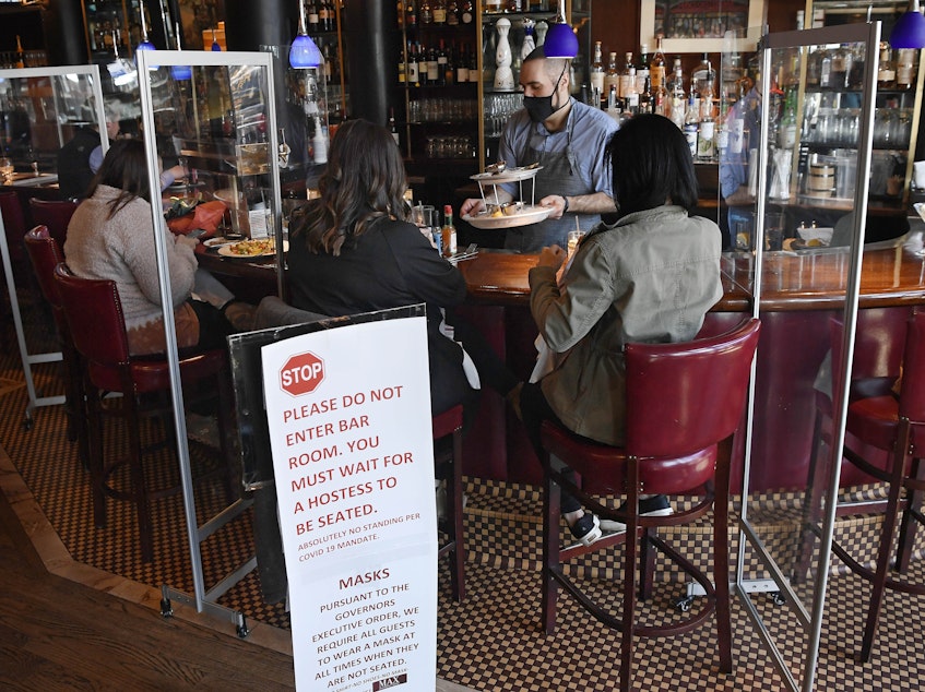 caption: Diners eat lunch at Max's Oyster Bar in West Hartford, Conn., on March 19. Retail sales surged last month as $1,400 relief payments and easing coronavirus restrictions led shoppers to open their wallets.