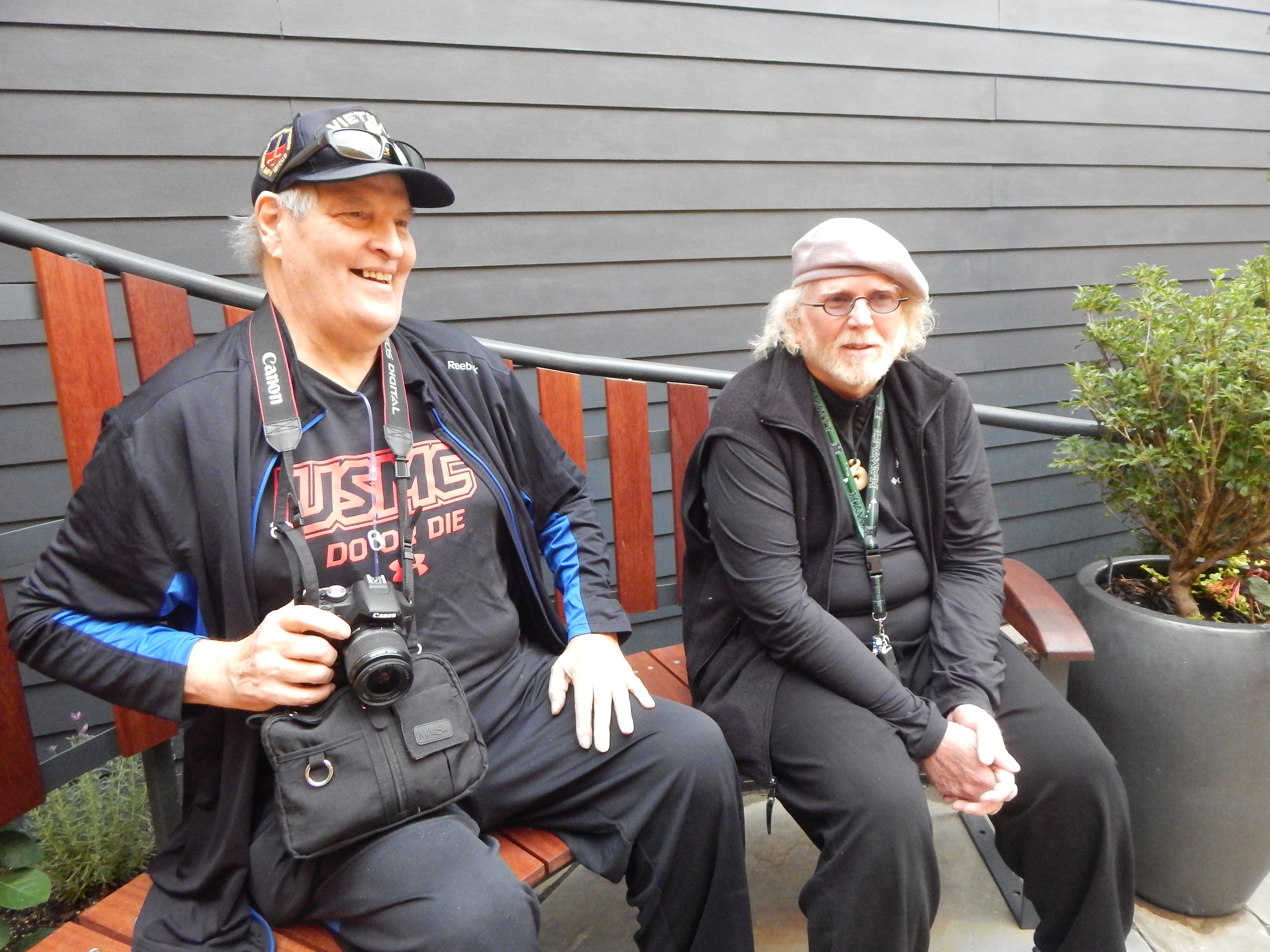 caption: Marine veteran Jack Kegley and UW Assistant Professor Jeremy Watson enjoy the new healing garden built by UW students. 