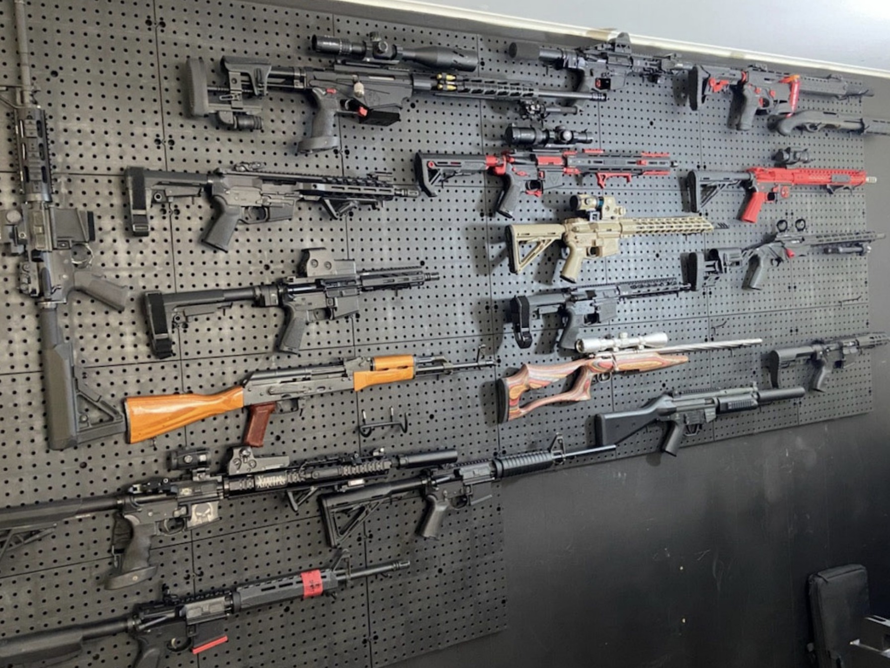 caption: A wall in a "gun room" in Brian Downey's house held a range of powerful weapons, many of which were not registered, authorities say.