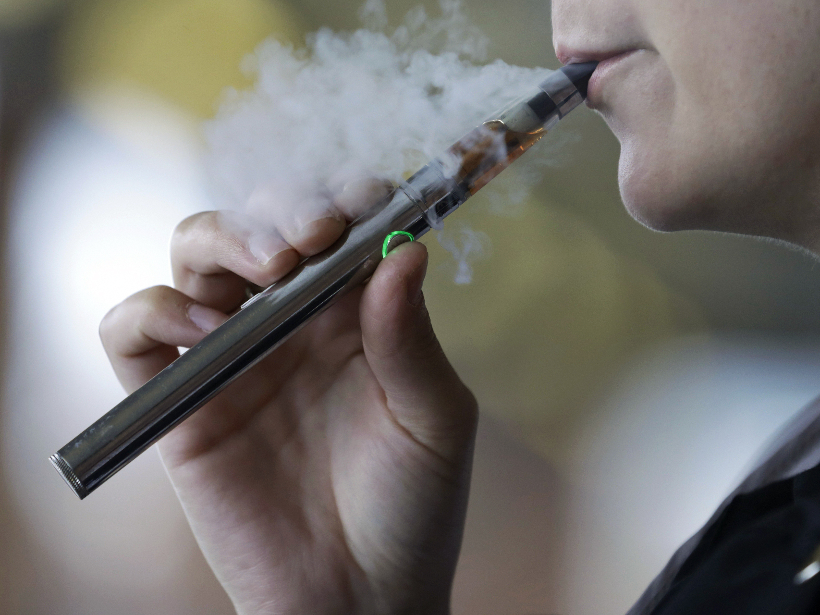 caption: Congress is trying to crack down on teenagers and young adults using tobacco products, including e-cigarettes.