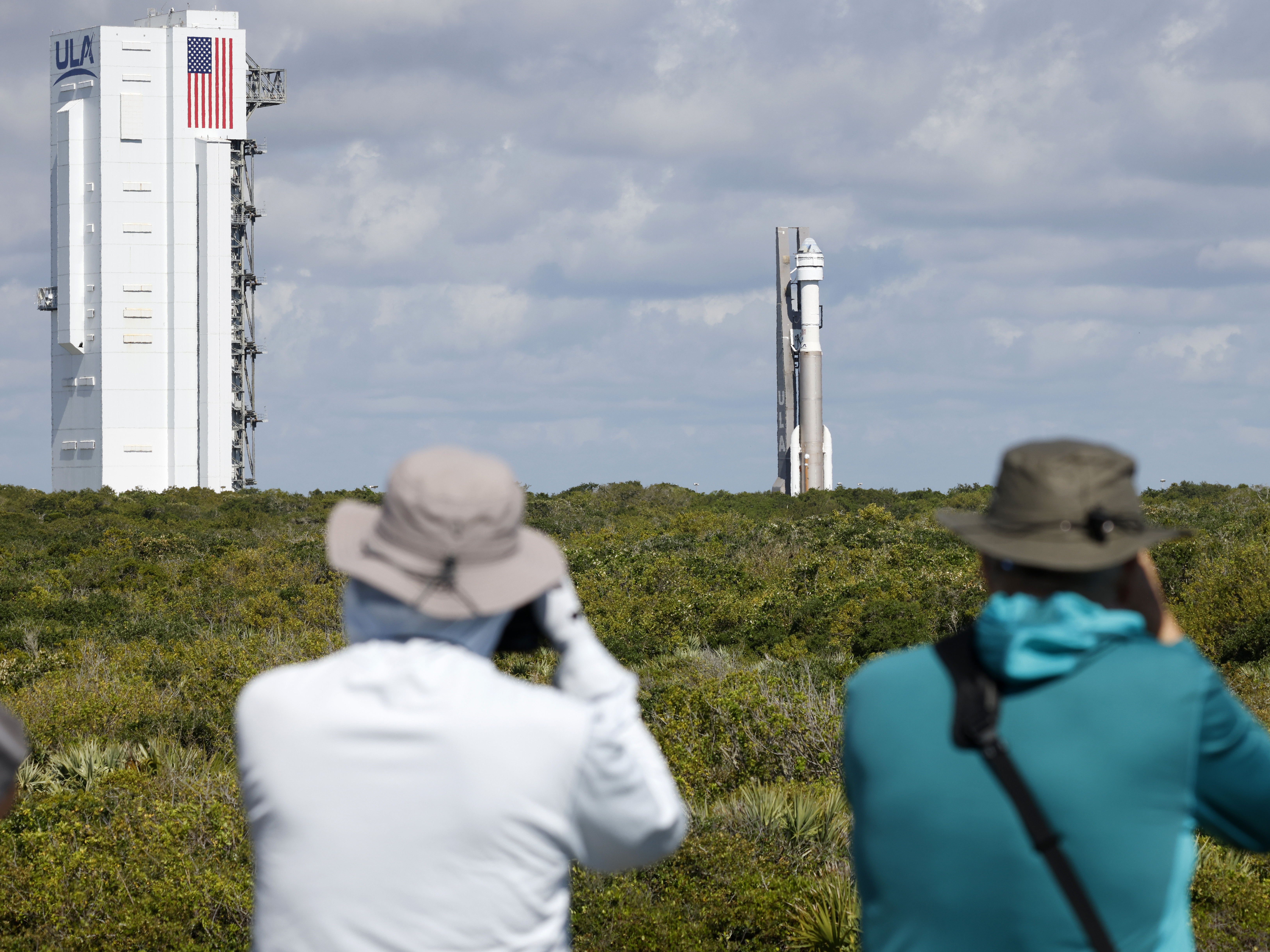 caption: Photographers capture the Boeing Starliner capsule atop an Atlas V rocket as it is rolled out to the launch pad at Space Launch Complex 41, Saturday, May 4, 2024, in Cape Canaveral, Fla.